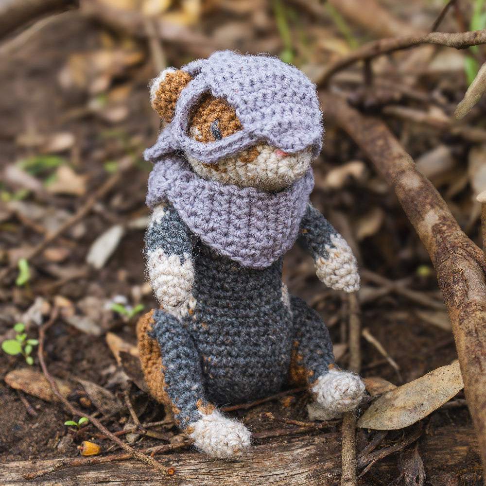 Amigurumi crochet medieval fantasy hamster sitting on a log