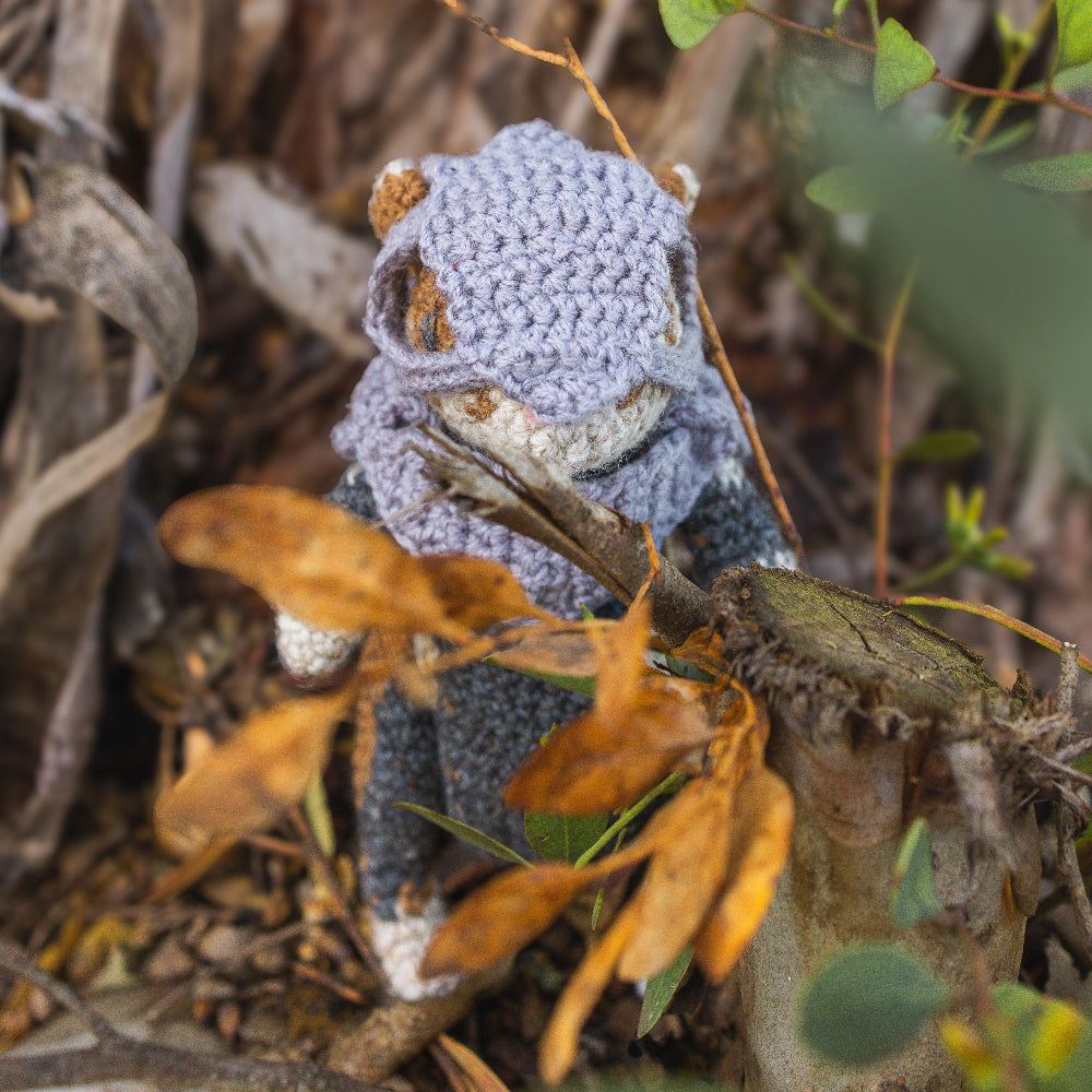 Amigurumi crocheted toy medieval fantasy hamster posed in nature