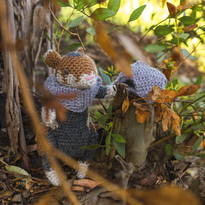 Amigurumi crochet medieval fantasy hamster posed in nature